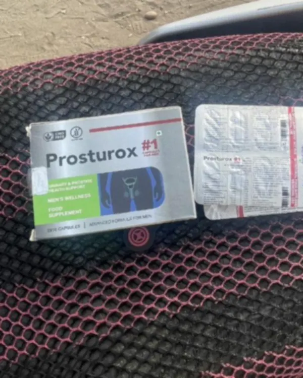 Boîte argentée de Prosturox et plaquette posées sur une selle de moto